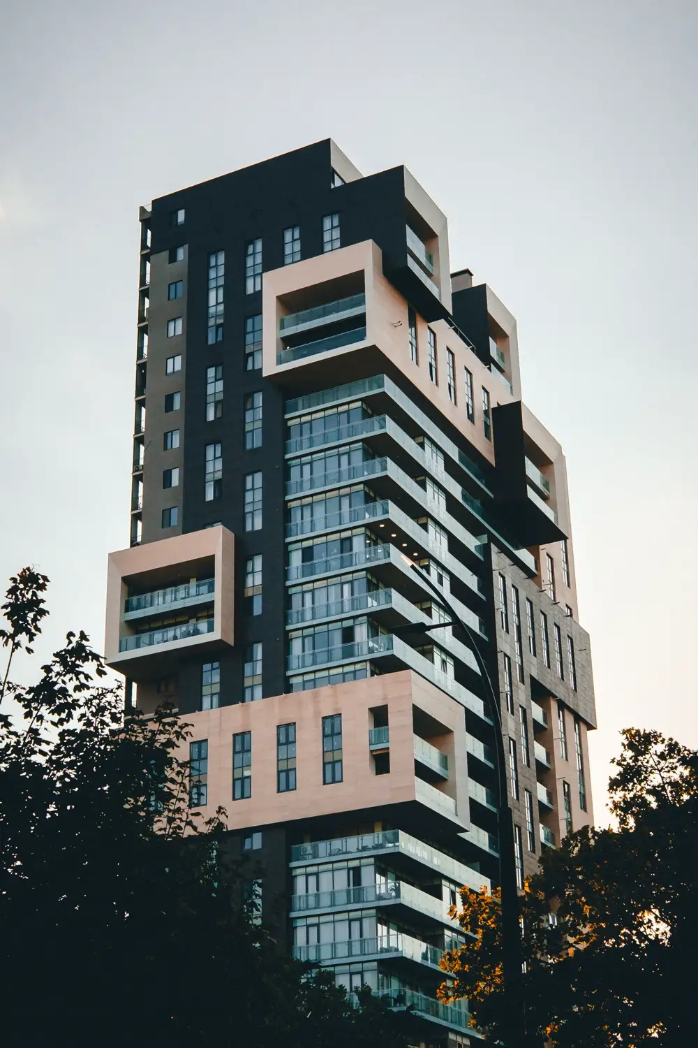 A sculptural apartment tower with stacked balconies